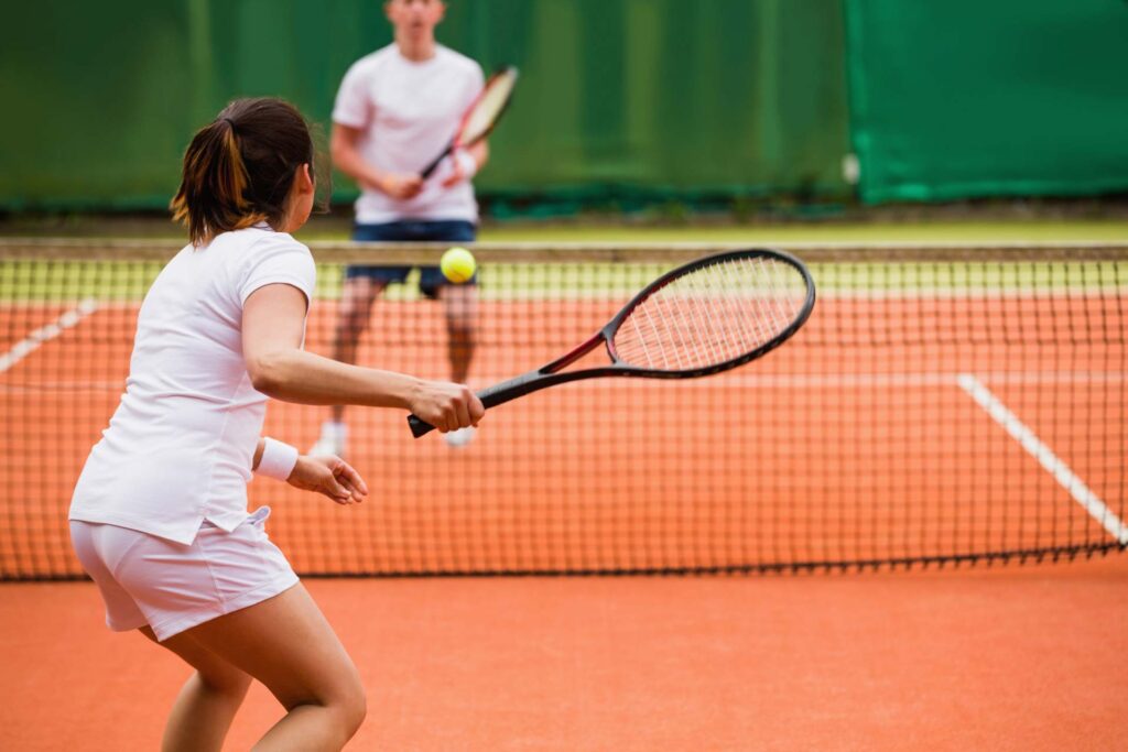 man and woman playing badminton game